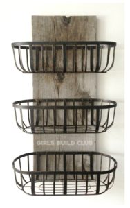 This easy project will help get some clutter off your kitchen or bathroom counter and onto the wall! The rustic wire baskets look great in a country farmhouse styled home or rustic cabin.