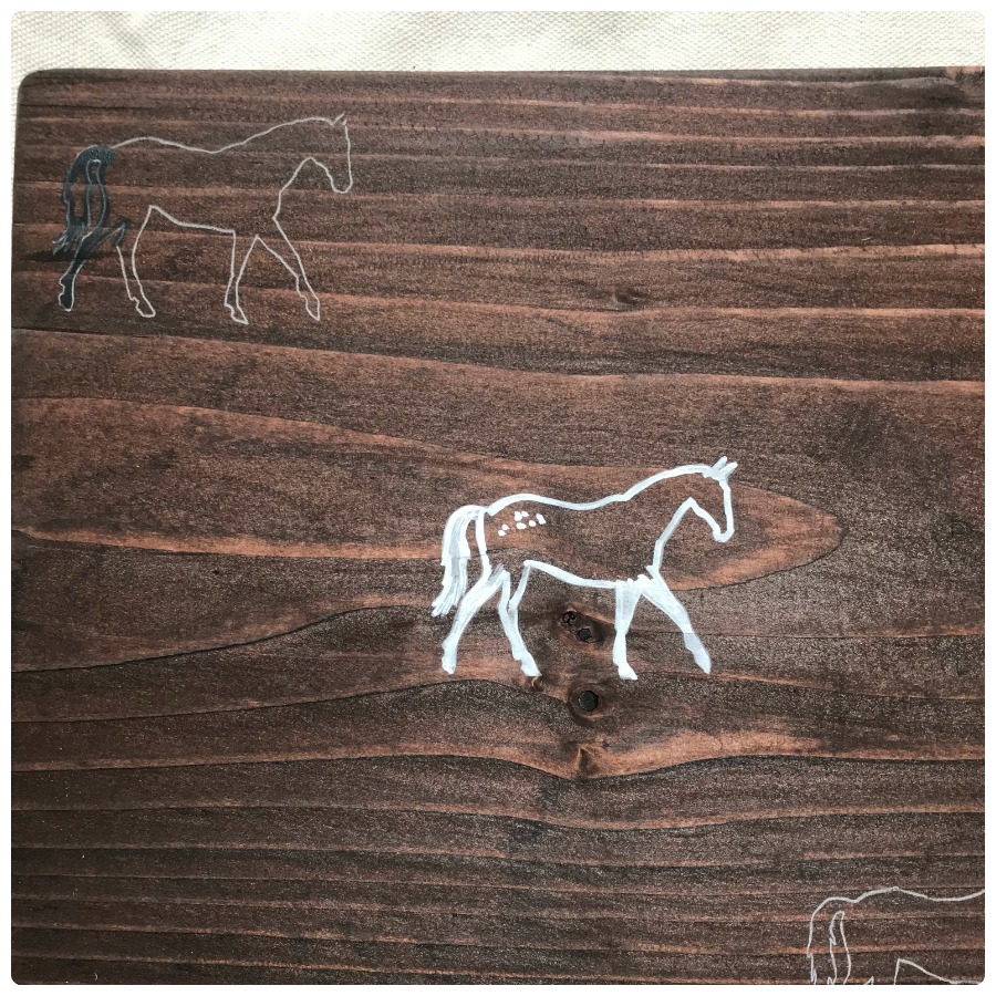 Tracing the horses with white paint pen