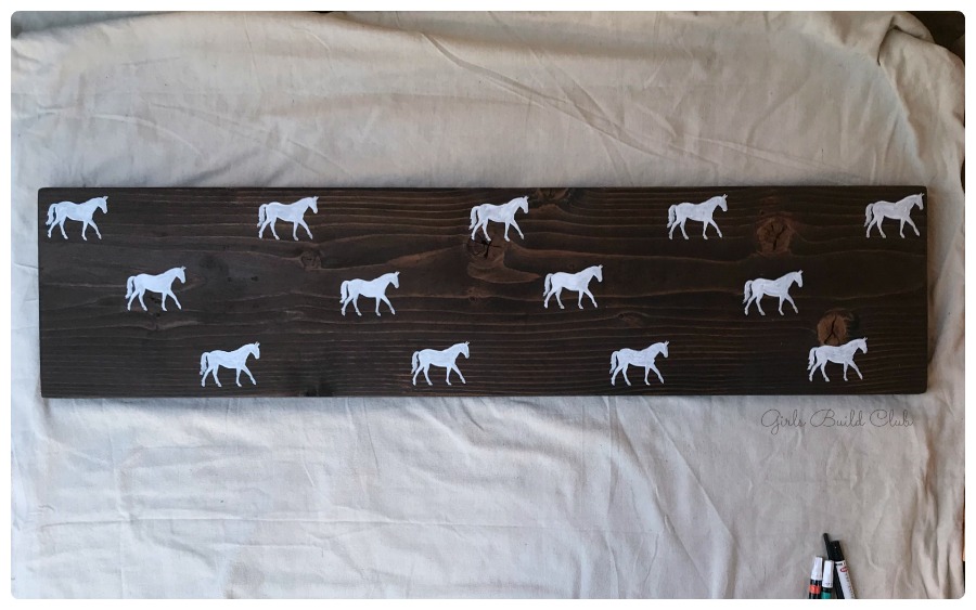 White horses painted on the bench. Painted Horse Bench DIY by Girls Build Club