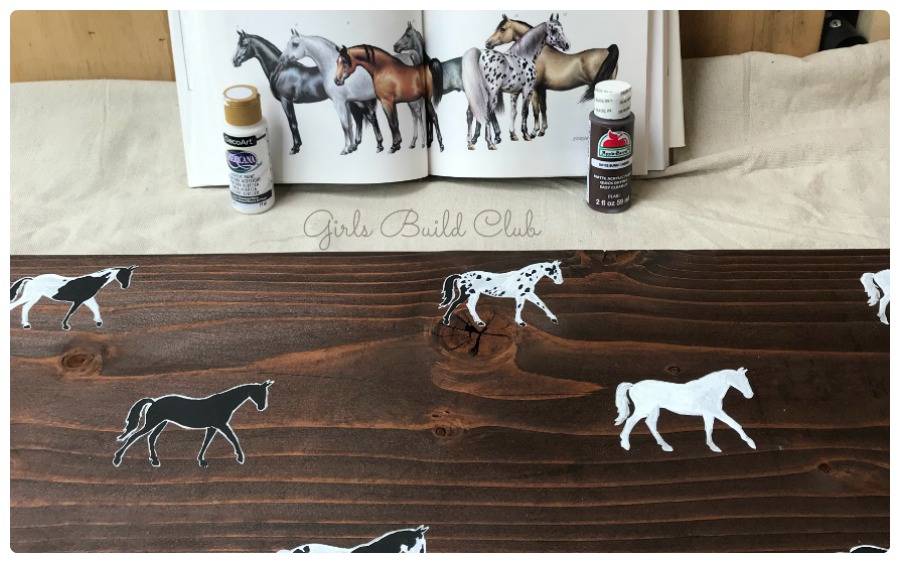 Studying how to paint the horses for this Painted Horse Bench DIY tutorial
