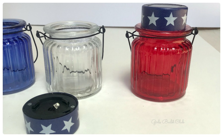 Arrange the solar light caps on the glass votive holders and glue them on to make your own cheap solar lanterns for the 4th of July! easy dollar store decor diy.