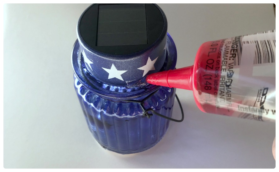 Arrange the solar light caps on the glass votive holders and glue them on to make your own cheap solar lanterns for the 4th of July! easy dollar store decor diy.