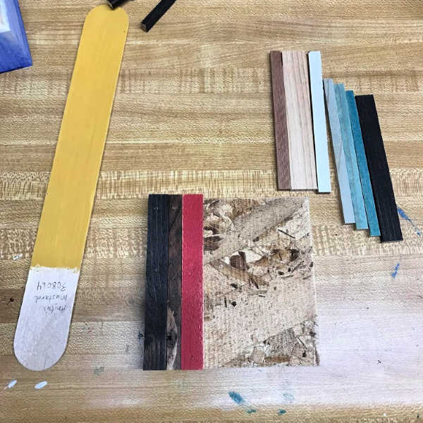 Lay out the strips of wood for your simple wood mosaic diy project to figure out what looks best!