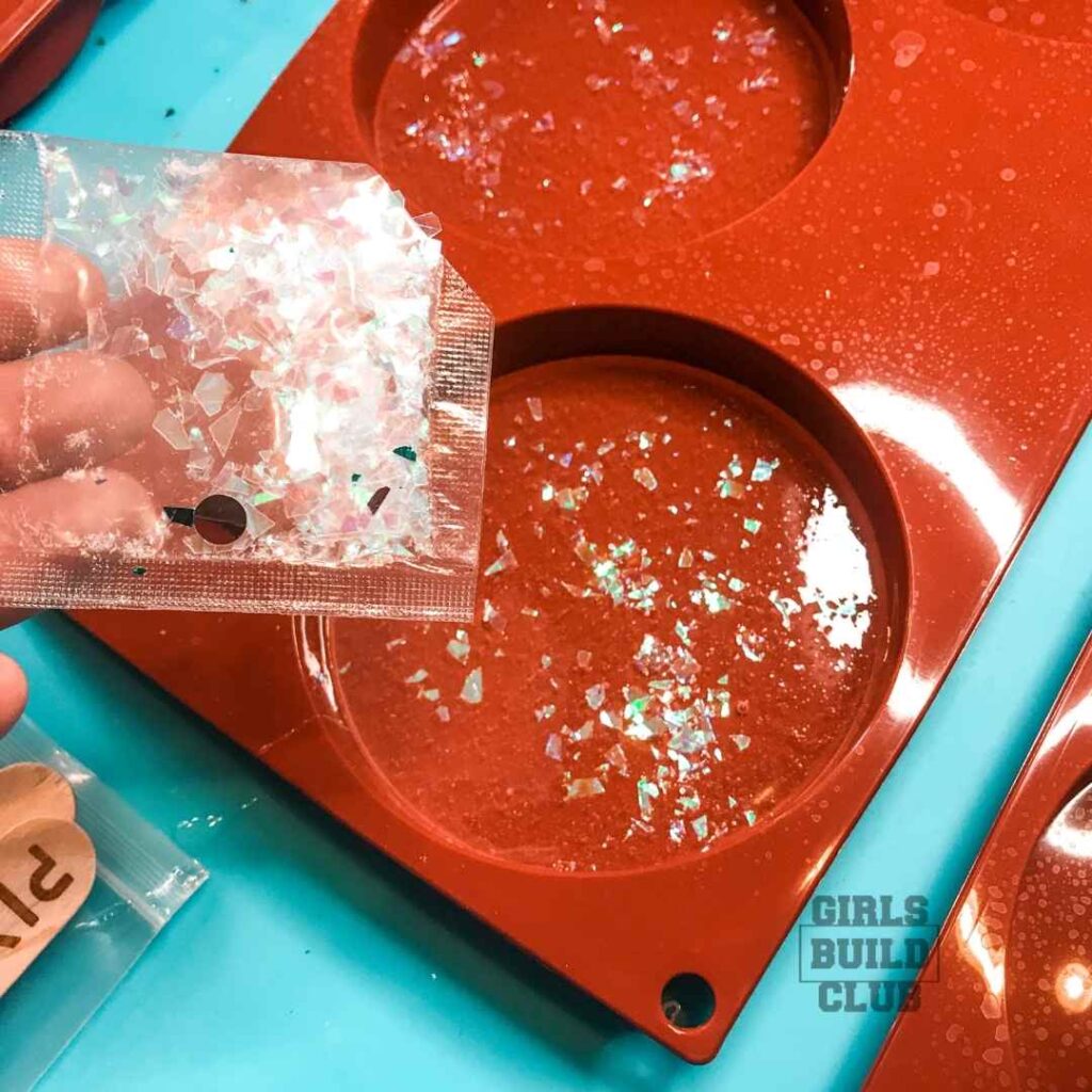 Pour some sparkly confetti in first, then add the candy hearts.